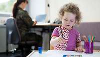 Eine Soldatin mit ihrer Tochter im Eltern-Kind-Arbeitszimmer 