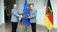 Zorn überreicht Bühler eine Urkundenmappe