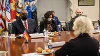 Minister Lambrecht sits at a conference table with Lloyd Austin and others
