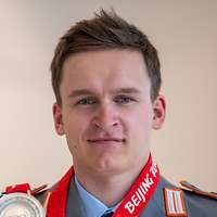 Der Athlet Julian Schmid hält seine Silber-Medaille hoch.