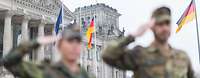 Soldaten posieren in einer gestellten Szene zum Thema Bundeswehr und Gesellschaft vor dem Reichstag in Berlin