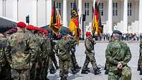 Deutsche Soldaten in Formation mit deutschen Flaggen