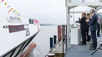 Mehrere Personen stehen klatschend vor einem Schiff.