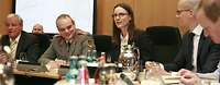 Suder am Tisch mit Soldaten und Zivilisten
